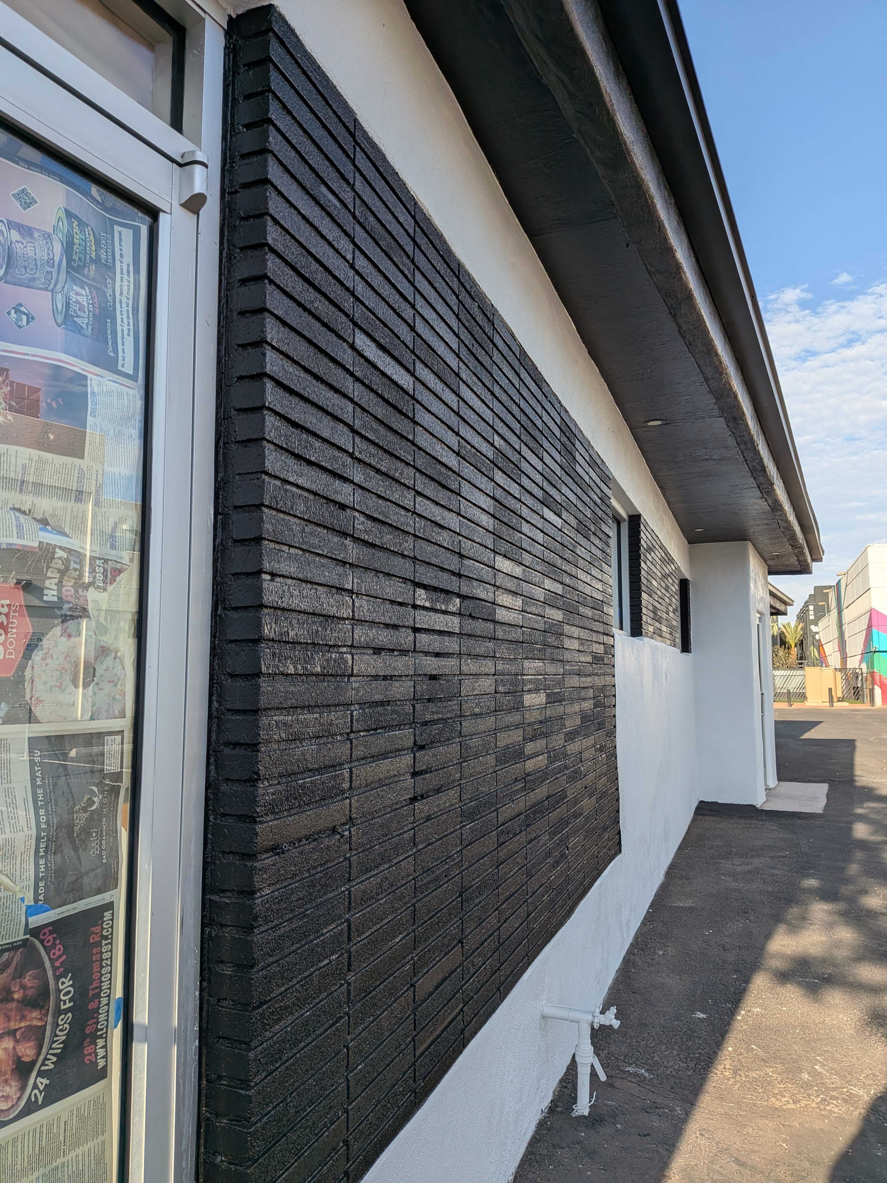 Commercial brick · black on white stucco